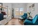 Cozy living room with plush armchairs, an ottoman, and a bright window with natural light at 729 Colby Pl, Durham, NC 27713