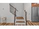 Stylish staircase with wooden steps, decorative iron railings, and natural light streaming in at 729 Colby Pl, Durham, NC 27713