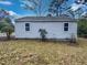 Backyard view of the home's siding and small plants growing against the home at 802 Powell Dr, Garner, NC 27529
