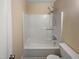 Bathroom featuring a standard tub shower with a white surround and updated showerhead fixture at 802 Powell Dr, Garner, NC 27529