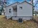 Side exterior view of home with light gray siding and trim, plus a covered porch at 802 Powell Dr, Garner, NC 27529