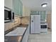 Bright kitchen featuring white appliances, cabinets, decorative backsplash, and light-colored tile floor at 802 Powell Dr, Garner, NC 27529