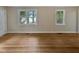 Bright living room featuring refinished hardwood floors, and natural light from two windows at 802 Powell Dr, Garner, NC 27529