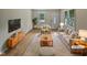 Bright living room featuring neutral decor, hardwood floors, and large windows with outdoor views at 802 Powell Dr, Garner, NC 27529