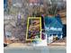 An aerial view of the property lot shows a defined parcel near a light blue two-story home at 822 Kent St, Durham, NC 27701