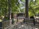 View from the back deck highlighting the brick exterior, screened-in porch, patio, and verdant surroundings at , Raleigh, NC 27613