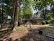 Exterior of brick home with a spacious backyard featuring a deck, patio, and lush greenery, perfect for outdoor living at , Raleigh, NC 27613