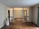 Open dining room with hardwood floors, columns, decorative wallpaper, and a chandelier at , Raleigh, NC 27613