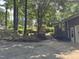 Brick home featuring an attached garage, mature trees, and professional landscaping with a concrete driveway at , Raleigh, NC 27613