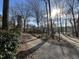 Charming brick home featuring a well-maintained yard with mature trees on a sunny day at , Raleigh, NC 27613