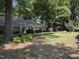Traditional brick home featuring a well-manicured front lawn and mature landscaping with trees and shrubs at , Raleigh, NC 27613