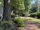 Well-maintained lawn with various trees and flowering bushes that add curb appeal to the classic brick home at , Raleigh, NC 27613