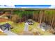 An aerial view showcases the home and its surroundings with mature trees and a circular driveway at 9230 Bear Run Ln, Middlesex, NC 27557