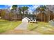 Attractive white house with an attached garage, complemented by an expansive driveway and manicured front yard at 9230 Bear Run Ln, Middlesex, NC 27557