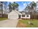 Charming white two-story home with a well-manicured lawn and attached two car garage at 9230 Bear Run Ln, Middlesex, NC 27557