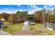 Charming home with a well-manicured lawn, complemented by towering trees and a blue sky backdrop at 9230 Bear Run Ln, Middlesex, NC 27557