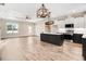 Open-concept kitchen featuring a large island, stainless steel appliances, and modern pendant lighting at 9230 Bear Run Ln, Middlesex, NC 27557
