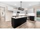 Modern kitchen featuring a large island, stylish pendant lighting, and stainless steel appliances at 9230 Bear Run Ln, Middlesex, NC 27557