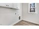 Laundry room with storage and a window for natural light at 9230 Bear Run Ln, Middlesex, NC 27557