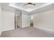 Bright and airy main bedroom featuring plush carpet and en suite bathroom at 9230 Bear Run Ln, Middlesex, NC 27557