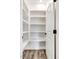 Walk-in pantry with ample shelving and storage space and a white door at 9230 Bear Run Ln, Middlesex, NC 27557