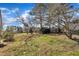 Large backyard with mature trees offers shade and privacy at 98 S Denise Ave, Coats, NC 27521