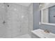 Bathroom featuring a sleek, modern design with a stand-up shower, and a white marble style tile at 98 S Denise Ave, Coats, NC 27521