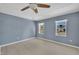 Cozy bedroom with calming neutral tones, ample natural light, and a ceiling fan at 98 S Denise Ave, Coats, NC 27521