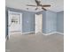 An open bedroom shows neutral colored walls and a ceiling fan for added comfort at 98 S Denise Ave, Coats, NC 27521