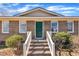 Welcoming front entrance featuring a brick facade, complemented by a vibrant green door and white trim at 98 S Denise Ave, Coats, NC 27521