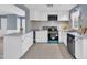 Bright kitchen featuring white cabinetry, stainless steel appliances and plenty of countertop space at 98 S Denise Ave, Coats, NC 27521