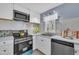 Modern kitchen with white cabinets, stainless steel appliances, and stylish countertop at 98 S Denise Ave, Coats, NC 27521