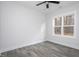 Light and airy bedroom with wood-look flooring is lit by two windows at 00 Cedar Grove Church Rd Rd, Roxboro, NC 27574