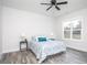 This bright bedroom has a ceiling fan, wood-look floors, and a decorative bedspread at 00 Cedar Grove Church Rd Rd, Roxboro, NC 27574