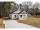 Charming one story home with concrete driveway, white siding and black roof at 00 Cedar Grove Church Rd Rd, Roxboro, NC 27574