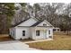 Charming one story home with concrete driveway, white siding and black roof at 00 Cedar Grove Church Rd Rd, Roxboro, NC 27574