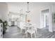 Eat-in kitchen with white cabinetry, stainless appliances, and a modern chandelier over the dining table at 00 Cedar Grove Church Rd Rd, Roxboro, NC 27574