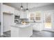 Bright kitchen with white cabinets, stainless appliances, a granite island, and a view of wooded backyard at 00 Cedar Grove Church Rd Rd, Roxboro, NC 27574