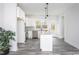 An open kitchen boasts white cabinets, stainless appliances, an island, and wood-look flooring at 00 Cedar Grove Church Rd Rd, Roxboro, NC 27574