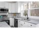 Beautiful kitchen with white cabinetry, stainless appliances, granite countertops, and backyard views at 00 Cedar Grove Church Rd Rd, Roxboro, NC 27574