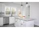 Bright kitchen features white cabinets, a stainless steel dishwasher, and a central island with a granite countertop at 00 Cedar Grove Church Rd Rd, Roxboro, NC 27574