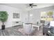 Bright living room featuring neutral walls, a ceiling fan, a gray loveseat, and wood-look flooring at 00 Cedar Grove Church Rd Rd, Roxboro, NC 27574