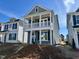Charming two-story home featuring a covered porch, neutral siding, and bright white trim at 119 Buckhorn Branch Park # 167, Clayton, NC 27520