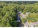 Picturesque aerial view of townhomes nestled in a lush, green, wooded community at 131 Carriage House Trl, Garner, NC 27529