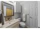 Neutral bathroom featuring a framed mirror and vanity with storage at 131 Carriage House Trl, Garner, NC 27529