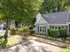 Charming home with light blue siding, mature trees, and a neat, fenced yard at 131 Carriage House Trl, Garner, NC 27529
