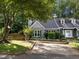 Charming home with a well-manicured lawn, inviting driveway, mature trees and lovely curb appeal at 131 Carriage House Trl, Garner, NC 27529