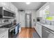 Bright kitchen featuring stainless steel appliances and granite countertops at 131 Carriage House Trl, Garner, NC 27529