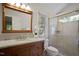 Bathroom with a wood vanity, granite counters, and a glass-enclosed shower at 1402 Princess Anne Rd, Cary, NC 27513