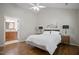 Bedroom with wood floors, a ceiling fan, and an ensuite bathroom with a wood vanity at 1402 Princess Anne Rd, Cary, NC 27513